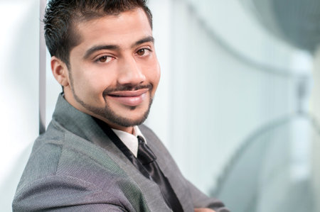 Young Eastern businessman inside an office buildingの写真素材