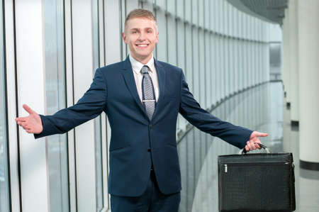 Portrait of a young smiling businessman in a business buildingの写真素材