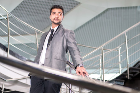 Young Eastern businessman inside an office buildingの写真素材