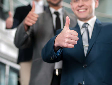 Group of young cheerful business people in business buildingの写真素材
