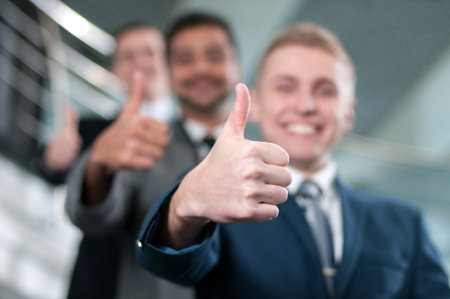 Group of young cheerful business people in business buildingの写真素材