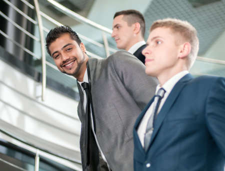 Group of young cheerful business people in business buildingの写真素材