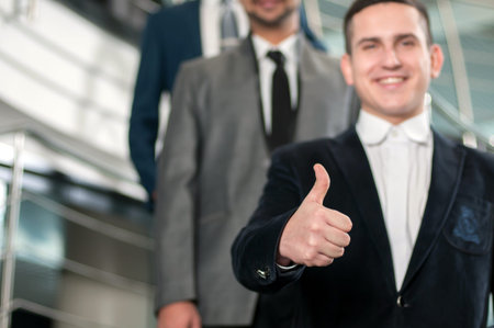 Group of young cheerful business people in business buildingの写真素材