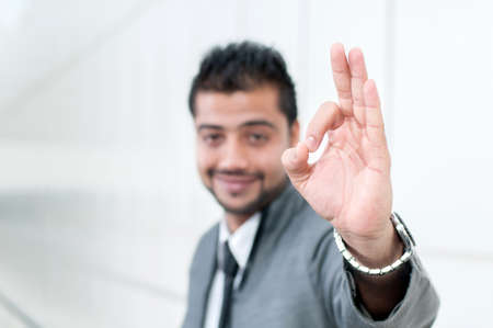 Young Eastern businessman inside an office buildingの写真素材
