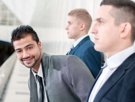 Group of young cheerful business people in business buildingの写真素材