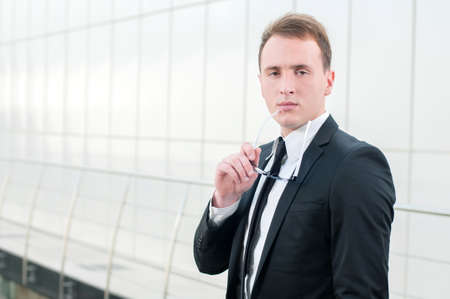 Portrait of a smiling handsome businessman at office buildingの写真素材