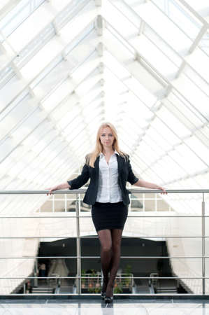 Portrait of a young beautiful business woman smiling at office buildingの写真素材