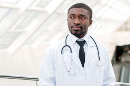 Young doctor standing with his stethoscope around his neckの写真素材