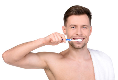 Young man brushing his teeth / Man brushing teeth isolated on white