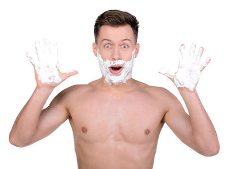 A shaving handsome man, isolated on whiteの写真素材