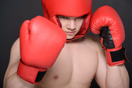 Young handsome boxer man isolated on black background