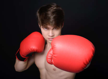 Young handsome boxer man isolated on black backgroundの写真素材