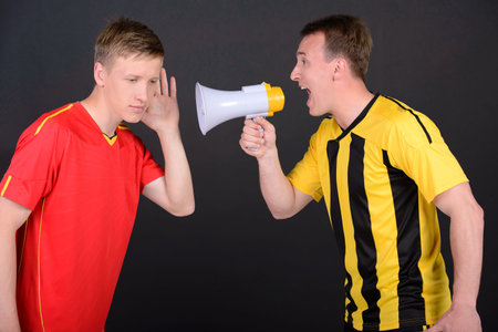 Soccer coach training with soccer men. Isolated on black background