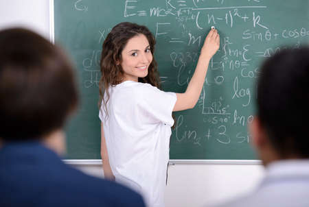 Group young students while studying in classroomの写真素材