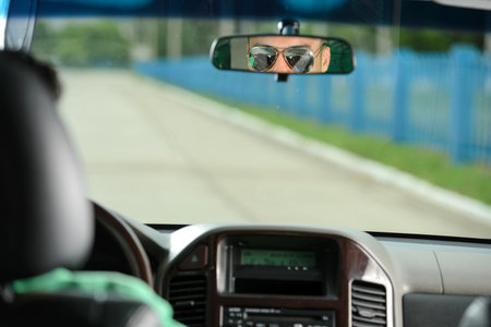 Portrait of young Indian business man, driving a carの写真素材