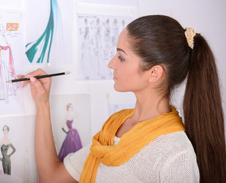 Portrait of a young woman, designer clothing, while working in his officeの写真素材