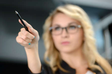 Portrait of a cute young business woman smiling, in an officeの写真素材