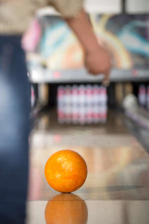 Young woman in club for bowling is throwing ball.の写真素材