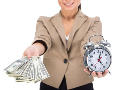 Young woman is holding in hand a lot american dollars and clock isolated on white .の写真素材