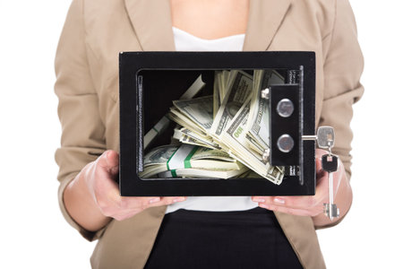 Young woman is holding safe with money, isolated on white background.の写真素材