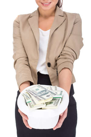 Young woman is holding a hat full of money, isolated on white background.の写真素材