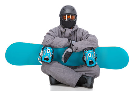 Portrait of young man in sportswear with snowboard isolated on a white .の写真素材