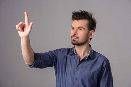 Innovation concept. Man is pushing on a touch screen interface. の写真素材