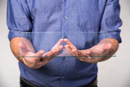 Close-up hands of a man is holding a glass. Innovation concept.