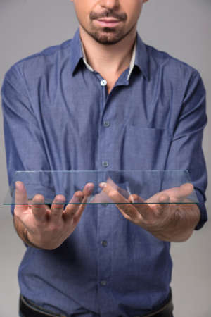 Close-up hands of a man is holding a glass. Innovation concept.の写真素材