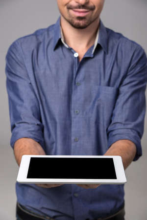 Close-up man is holding a digital tablet. Innovation concept.の写真素材