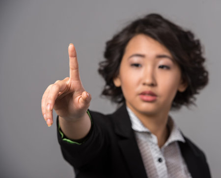 Innovation concept. Woman is pushing a touch screen interface  on a virtual .の写真素材