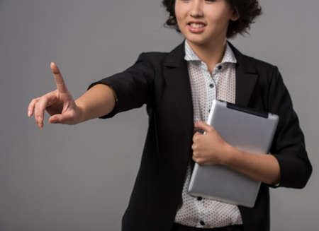 Innovation concept. Woman is pushing a touch screen interface  on a virtual .の写真素材