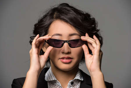 Portrait of a young girl is wearing glasses.の写真素材