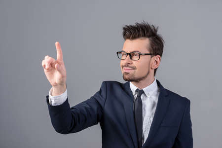 Innovation concept. Man is pushing on a touch screen interface. の写真素材