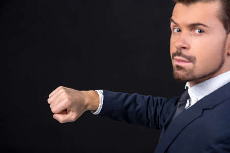 Innovation concept. Concept of time. Businessman is showing something at his hand.の写真素材