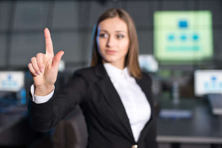 Portrait of a handsome young woman is standing in the background of the modern conference hall.の写真素材