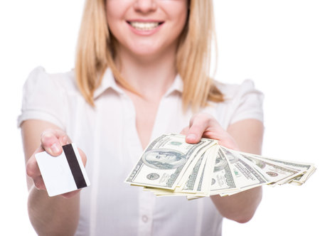 Young woman with dollars and card in her hands