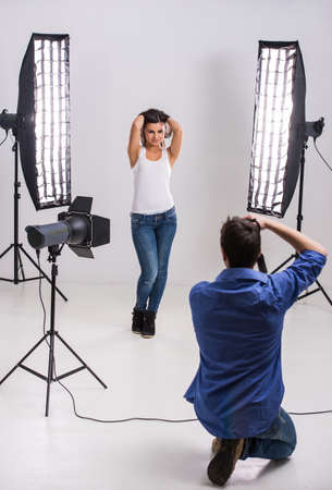 Photographer at work with model in the professionally equipped studio.の写真素材