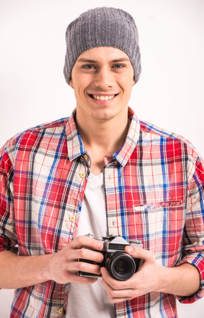 Portrait of handsome young man is holding vintage camera.の写真素材
