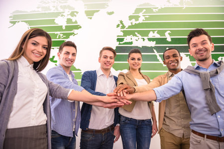 International business team are showing unity with their hands together.
