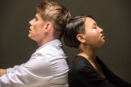 Young fashionable passionate couple dressed casual posing in the studio. Fashion portrait.の写真素材