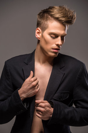 Young fashionable couple dressed casual posing in the studio on dark background. Fashion portrait.の写真素材