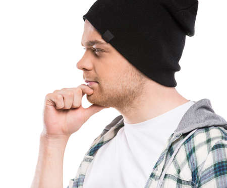 A portrait of a young handsome man lost in his thoughts. White background.の写真素材