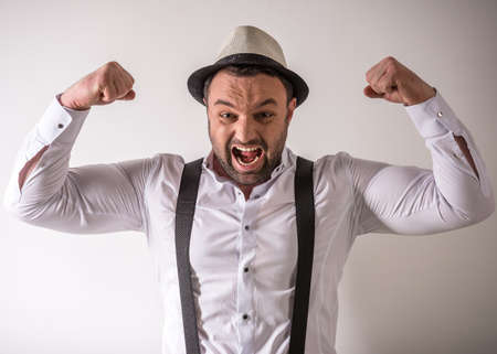 Mature handsome man in formal wear enjoying his success.の写真素材