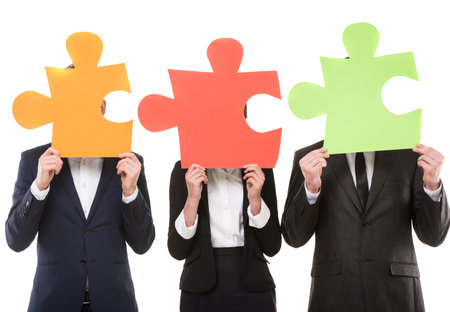 Image of business people wanting to put pieces of puzzle together.の写真素材