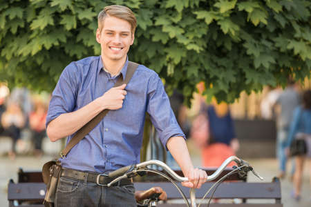Young handsome man dressed casual riding bicycle. Healthy lifestyle concept.の写真素材