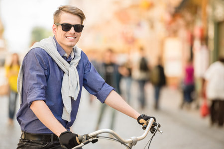 Young handsome man dressed casual riding bicycle. Healthy lifestyle concept.の写真素材