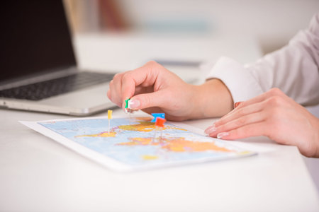 Travel or tourist concept - map and destination signs on it. Close-up.