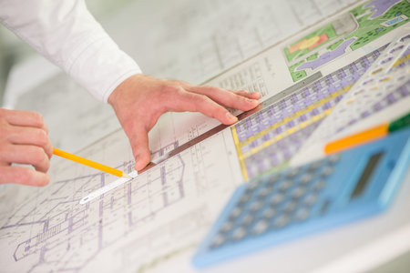 Close-up of male engineer sketching construction project.
