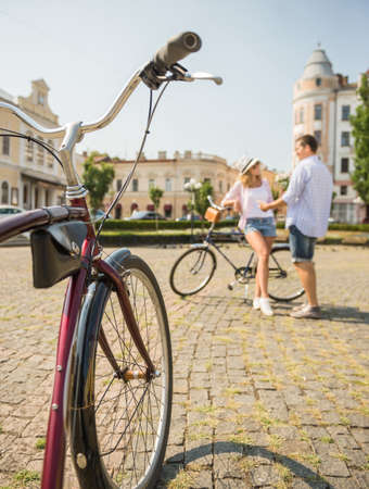 Bicycle on the road. Young couple met and looking to each other.の写真素材